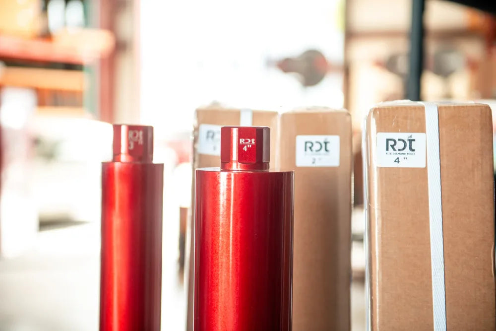 Red RDT core bits arranged by size beside labeled boxes
