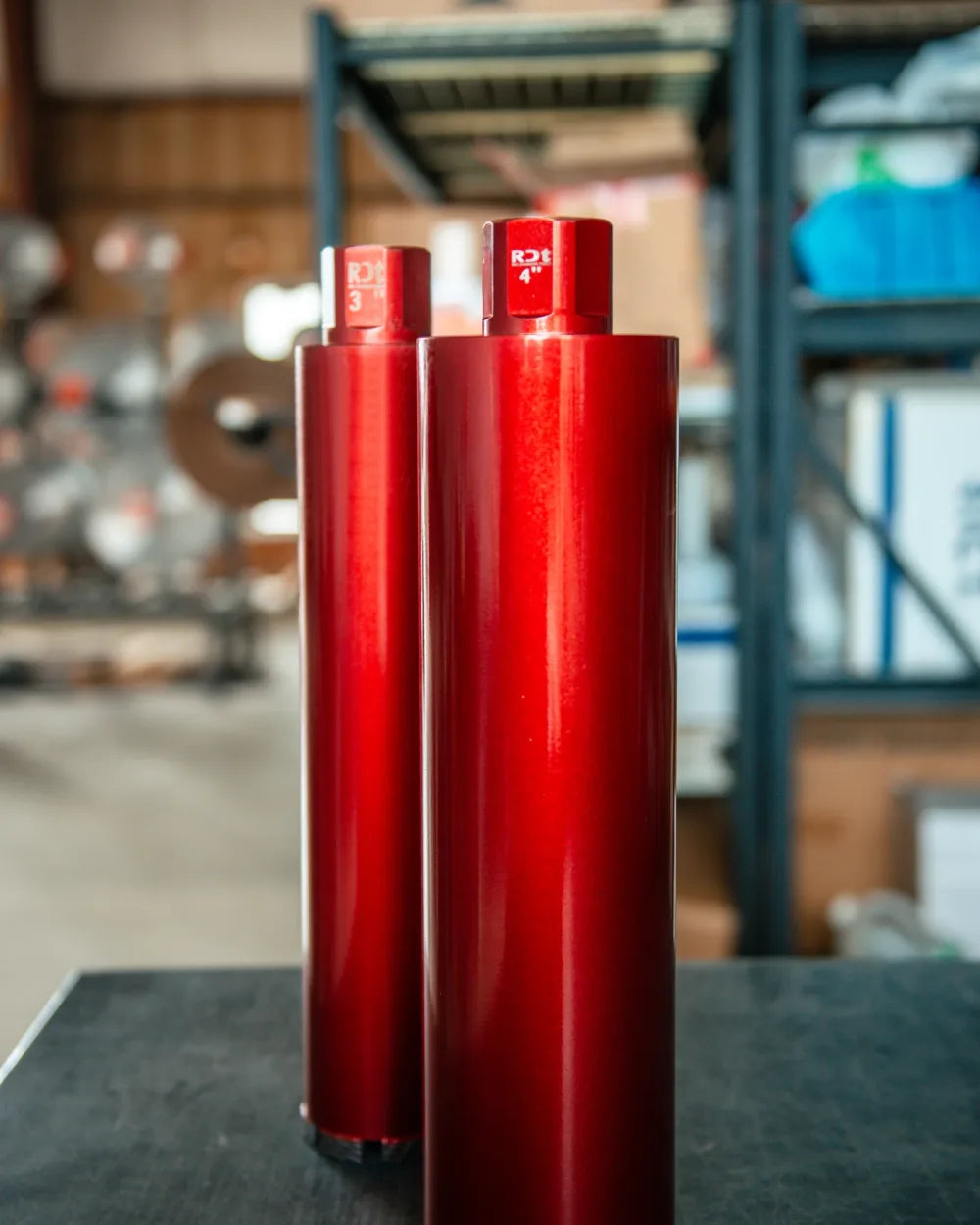 Red diamond core bits arranged by diameter in a studio lineup